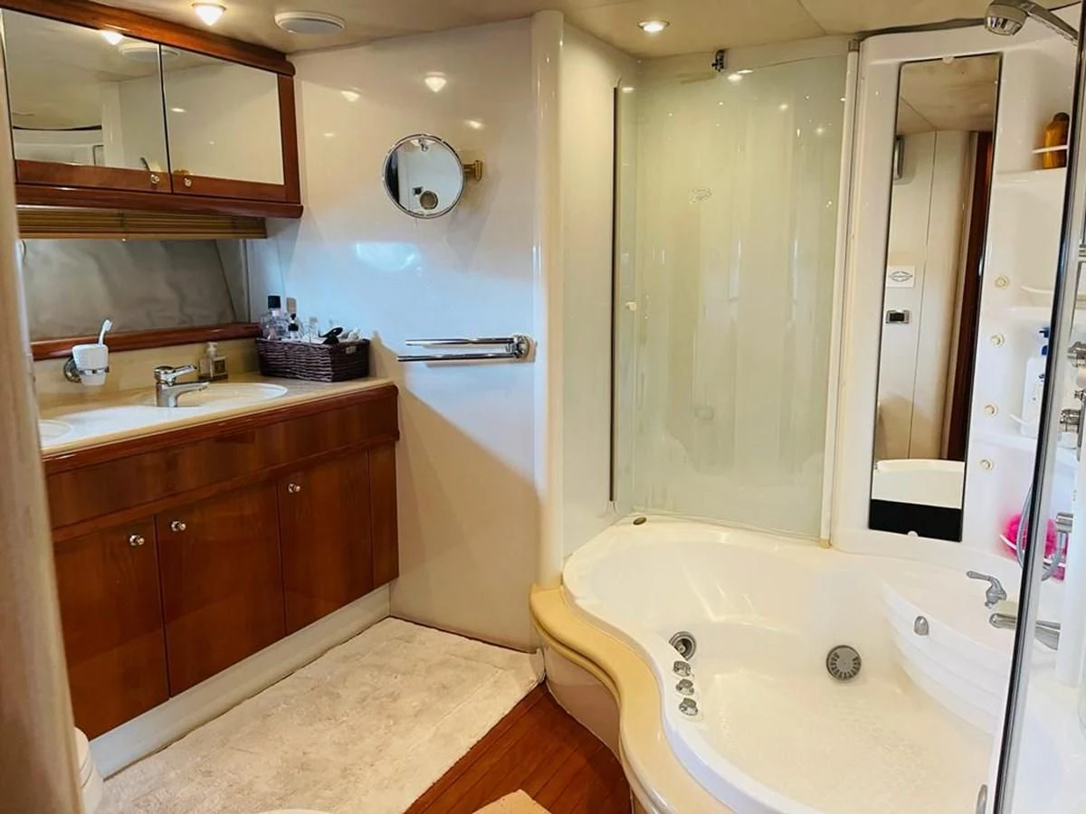 a bathroom with a tub sink and cabinets aboard LADY ESTHER Yacht for Sale
