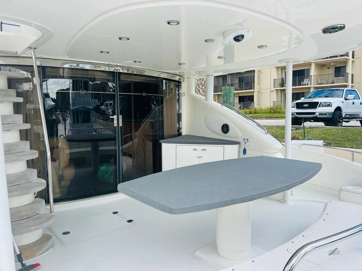 a large white table with chairs and a glass door aboard LADY ESTHER Yacht for Sale