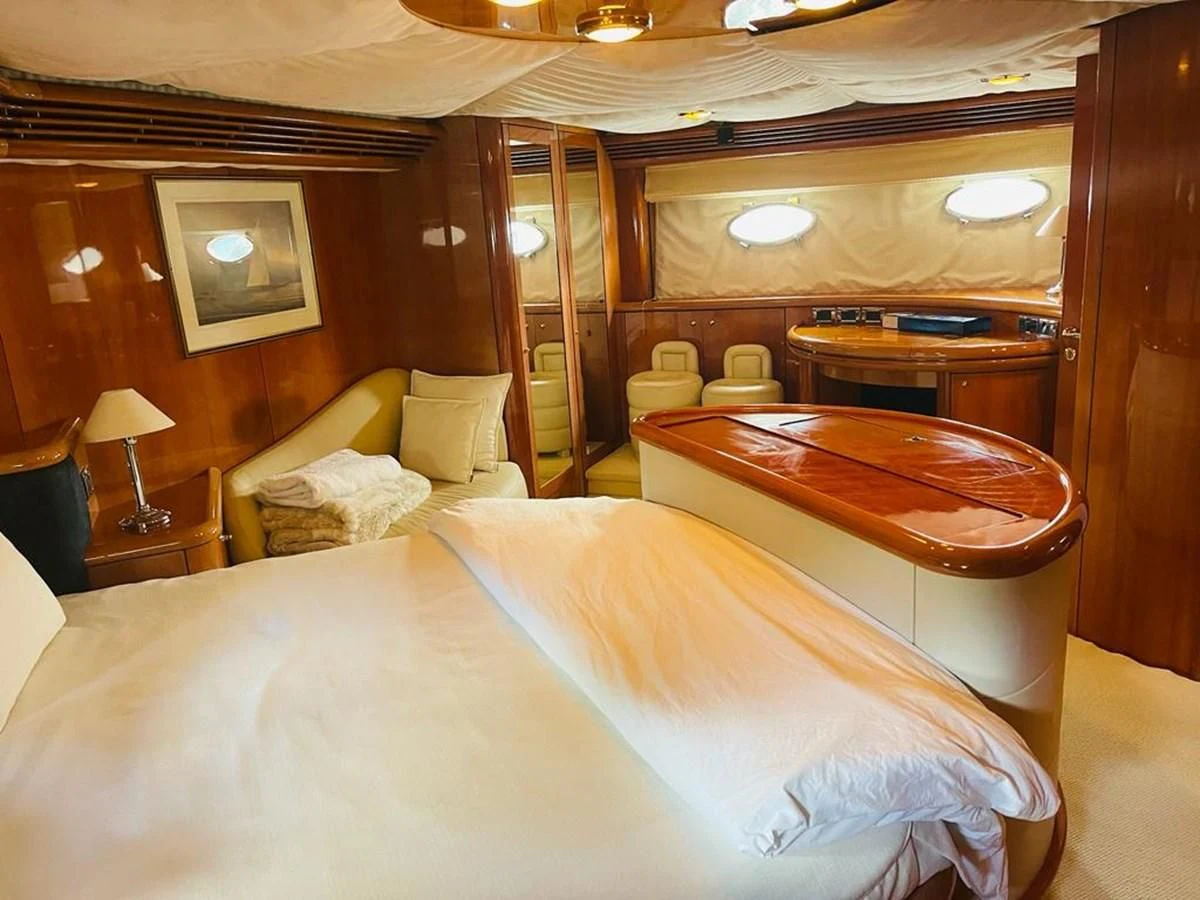 a room with a bed and a desk aboard LADY ESTHER Yacht for Sale