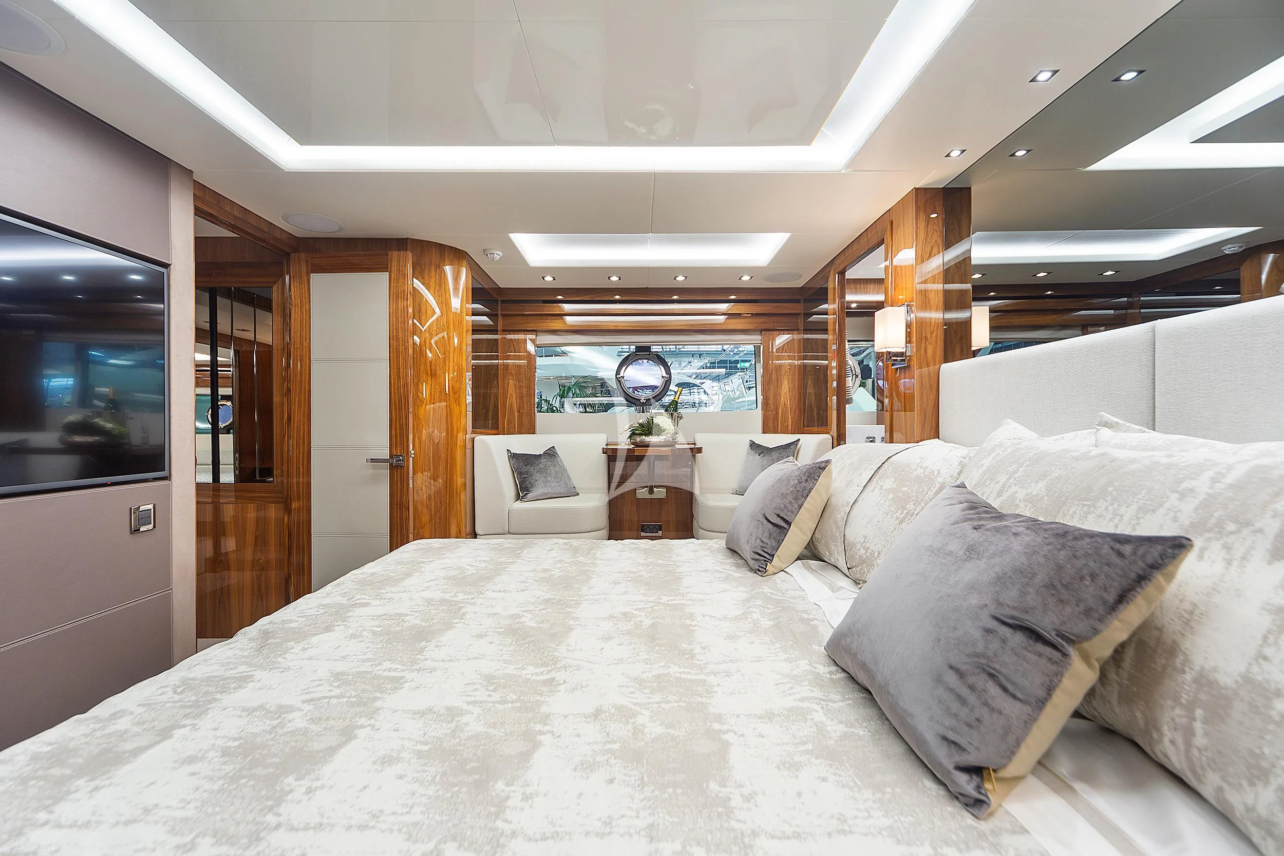 a bed with pillows and a television aboard BLUE INFINITY Yacht for Sale