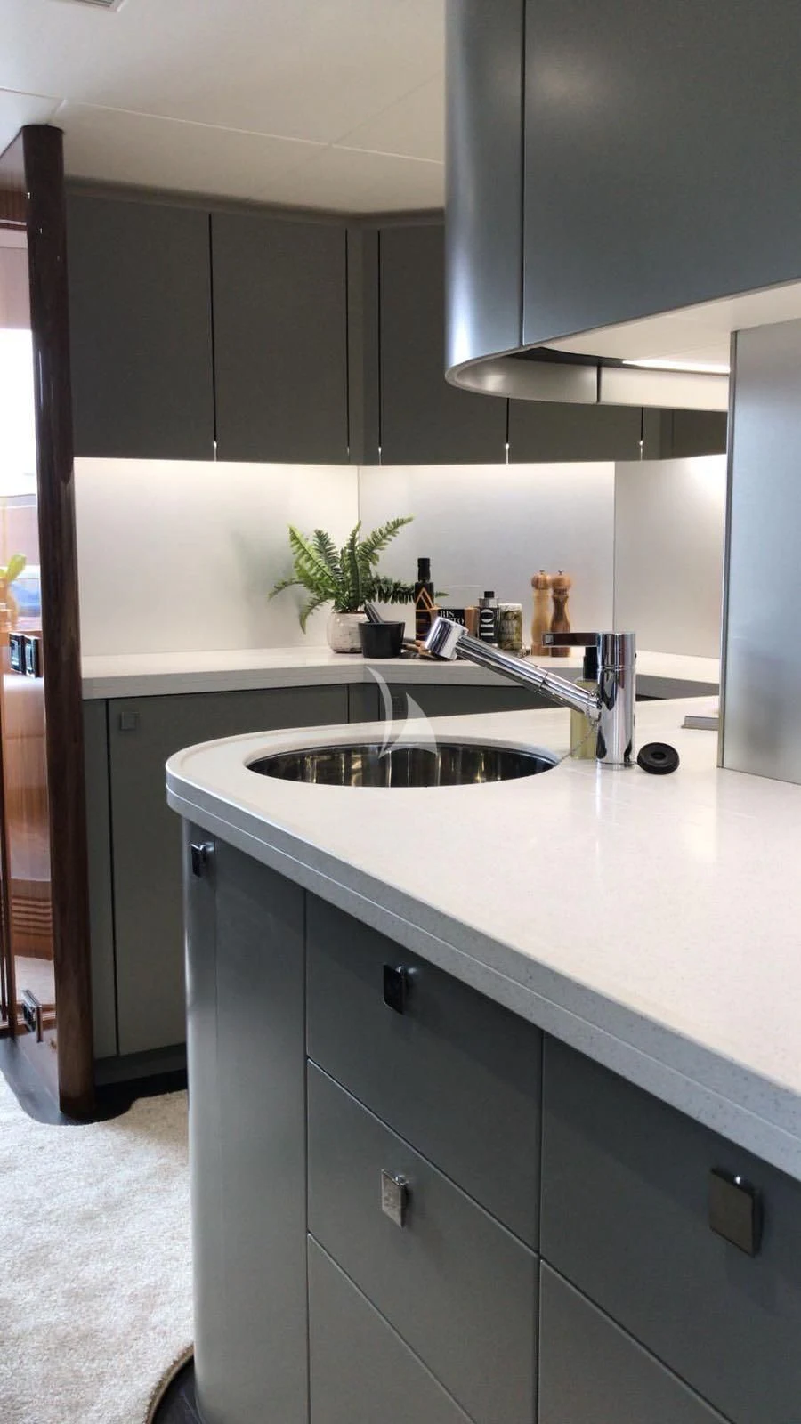 a kitchen with black cabinets aboard BLUE INFINITY Yacht for Sale