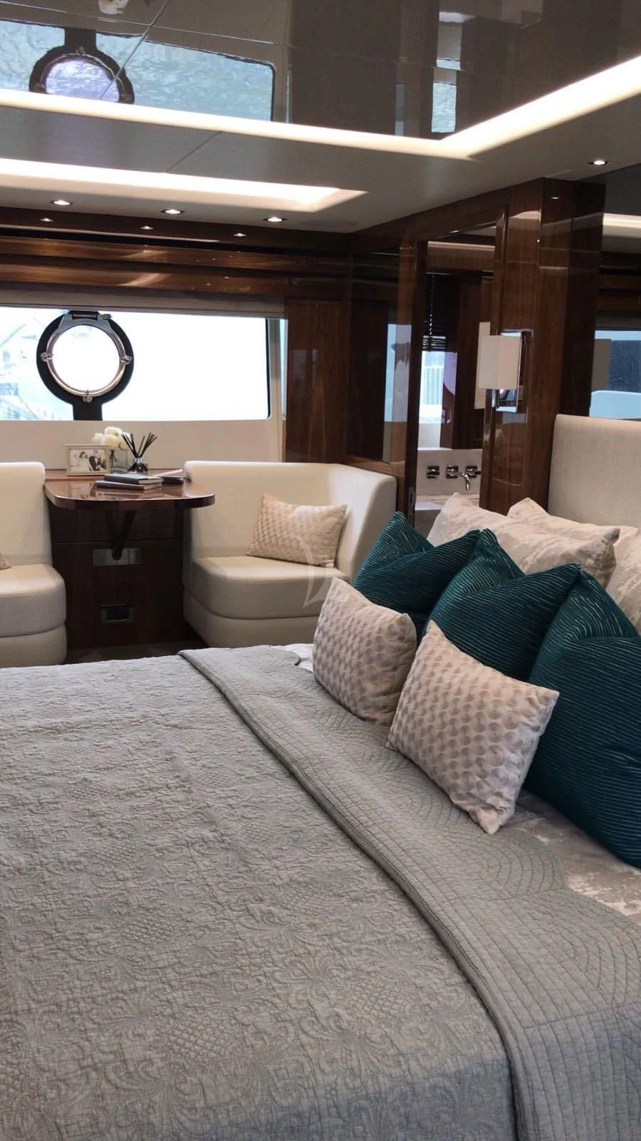 a bed with pillows and a mirror above it aboard BLUE INFINITY Yacht for Sale