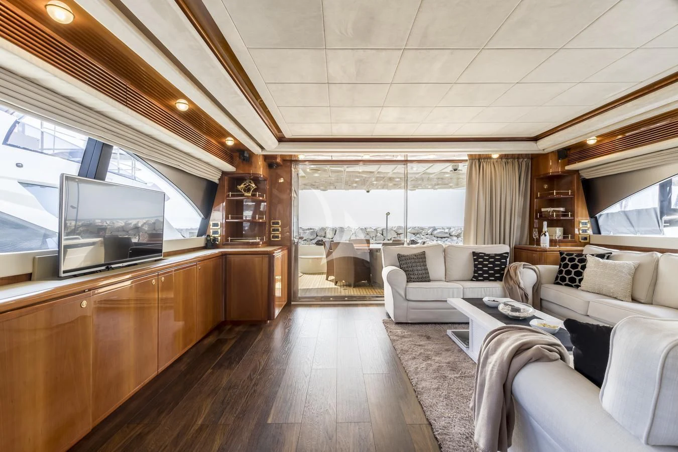a living room with a wood floor aboard MISS KATARIINA Yacht for Sale