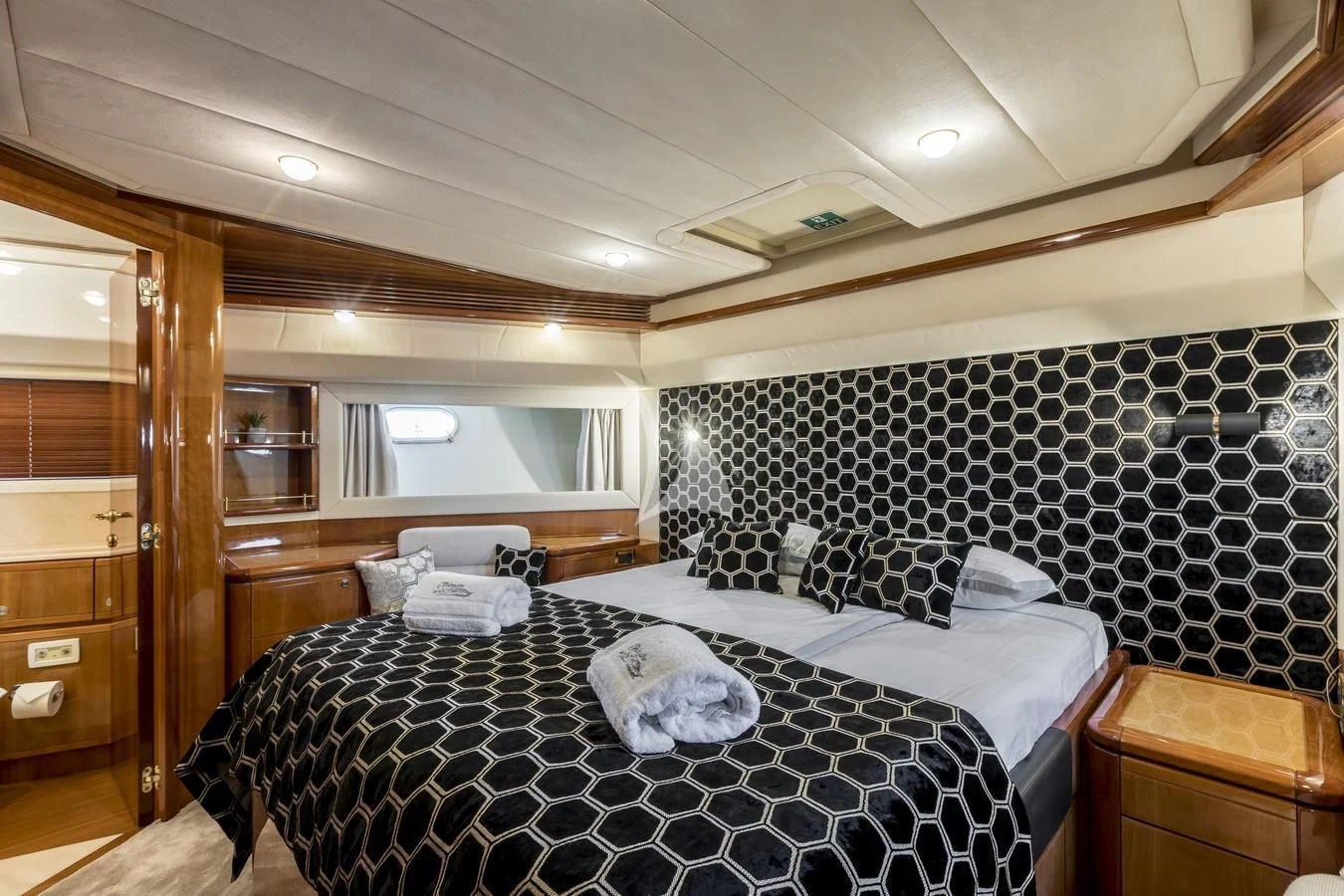 a bedroom with a bed and a dresser aboard MISS KATARIINA Yacht for Sale