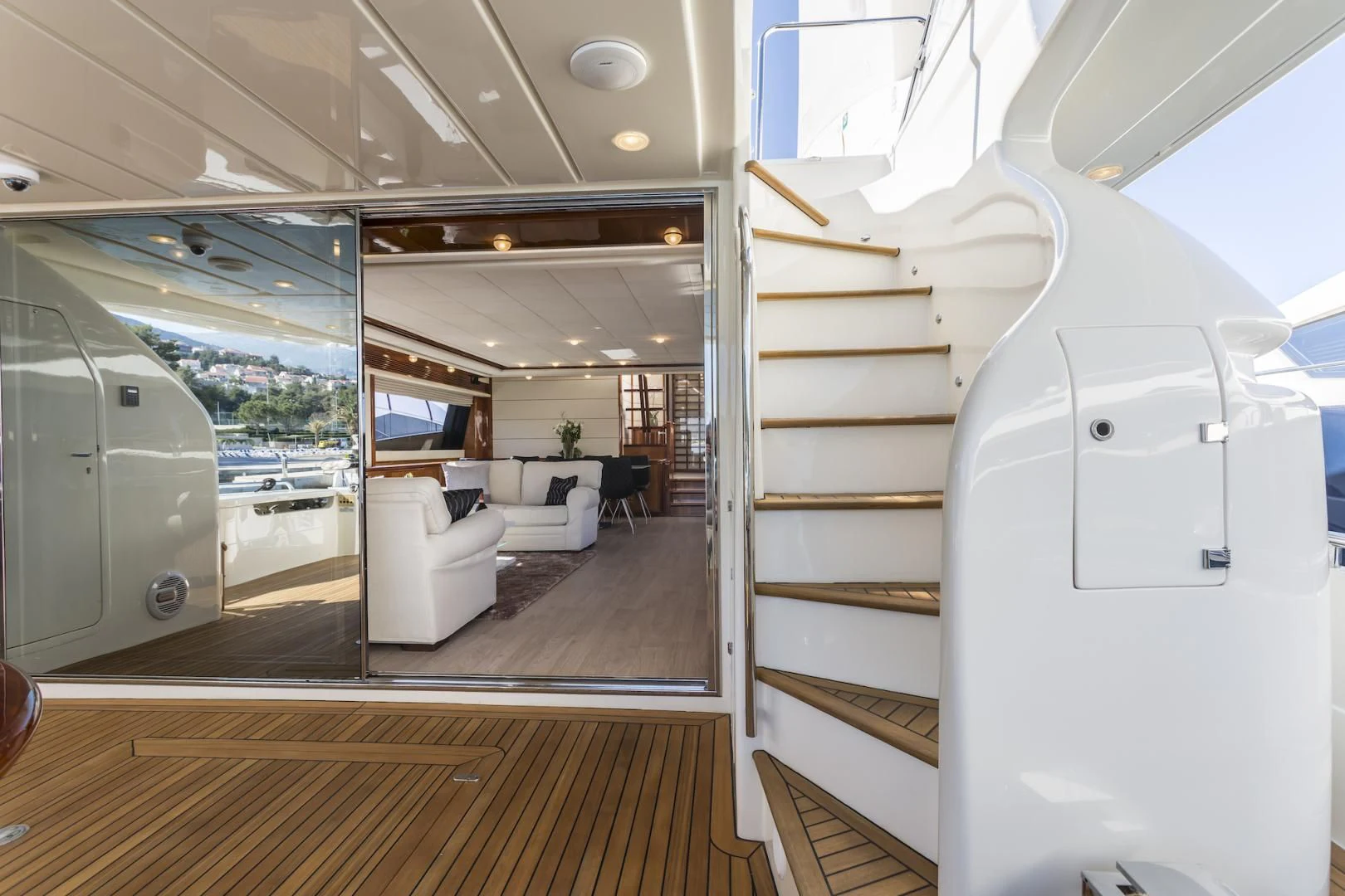 a room with a glass door and a white couch aboard MISS KATARIINA Yacht for Sale