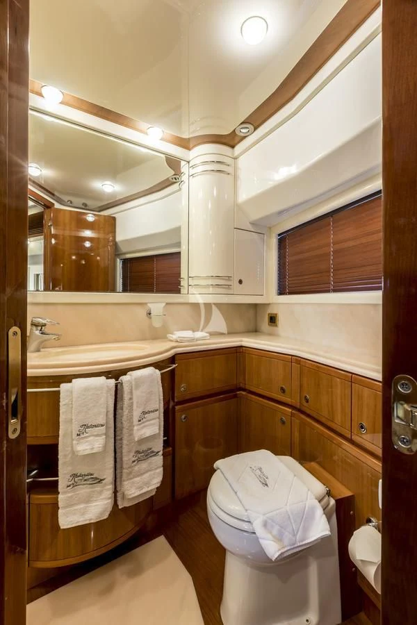 a bathroom with wooden cabinets aboard MISS KATARIINA Yacht for Sale