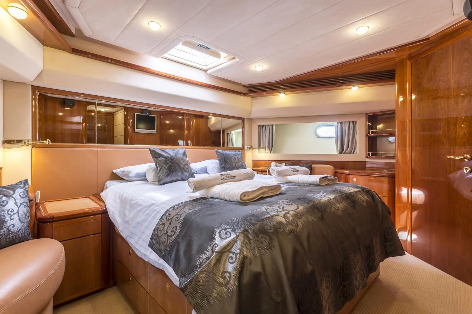 a room with a bed and a chair aboard MISS KATARIINA Yacht for Sale