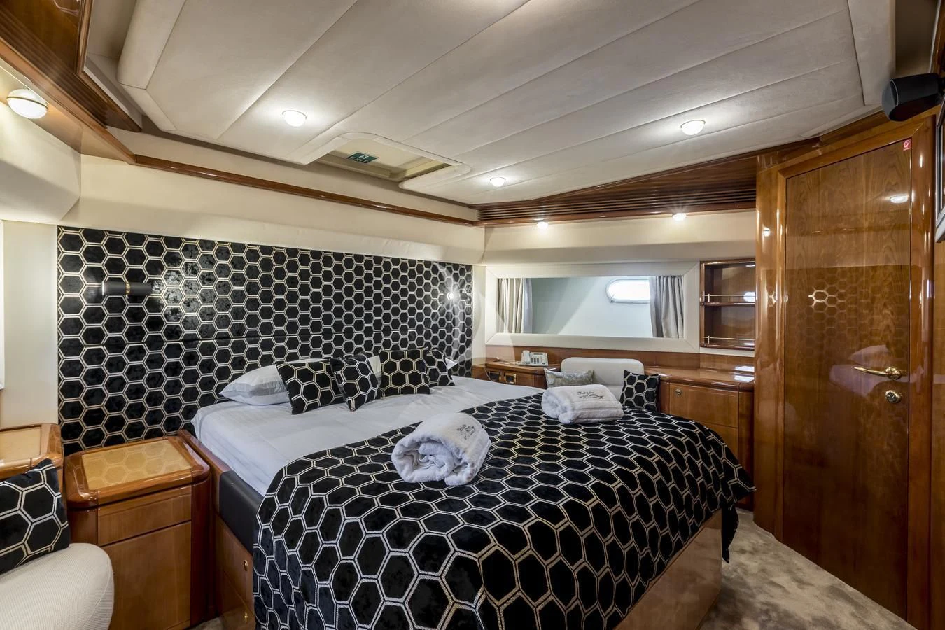 a bedroom with a bed and a wood door aboard MISS KATARIINA Yacht for Sale