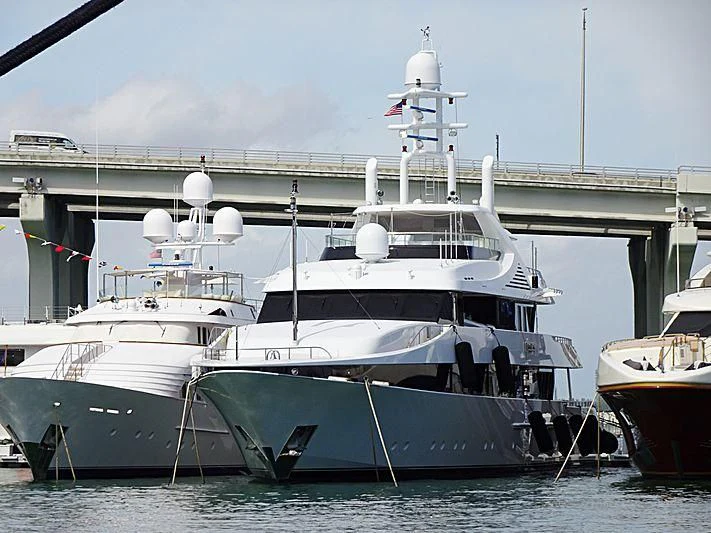 a large white boat sits in the water aboard KISSES Yacht for Sale