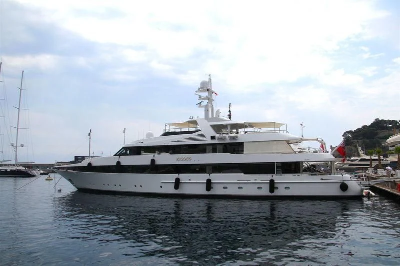 a large white boat in a harbor aboard KISSES Yacht for Sale