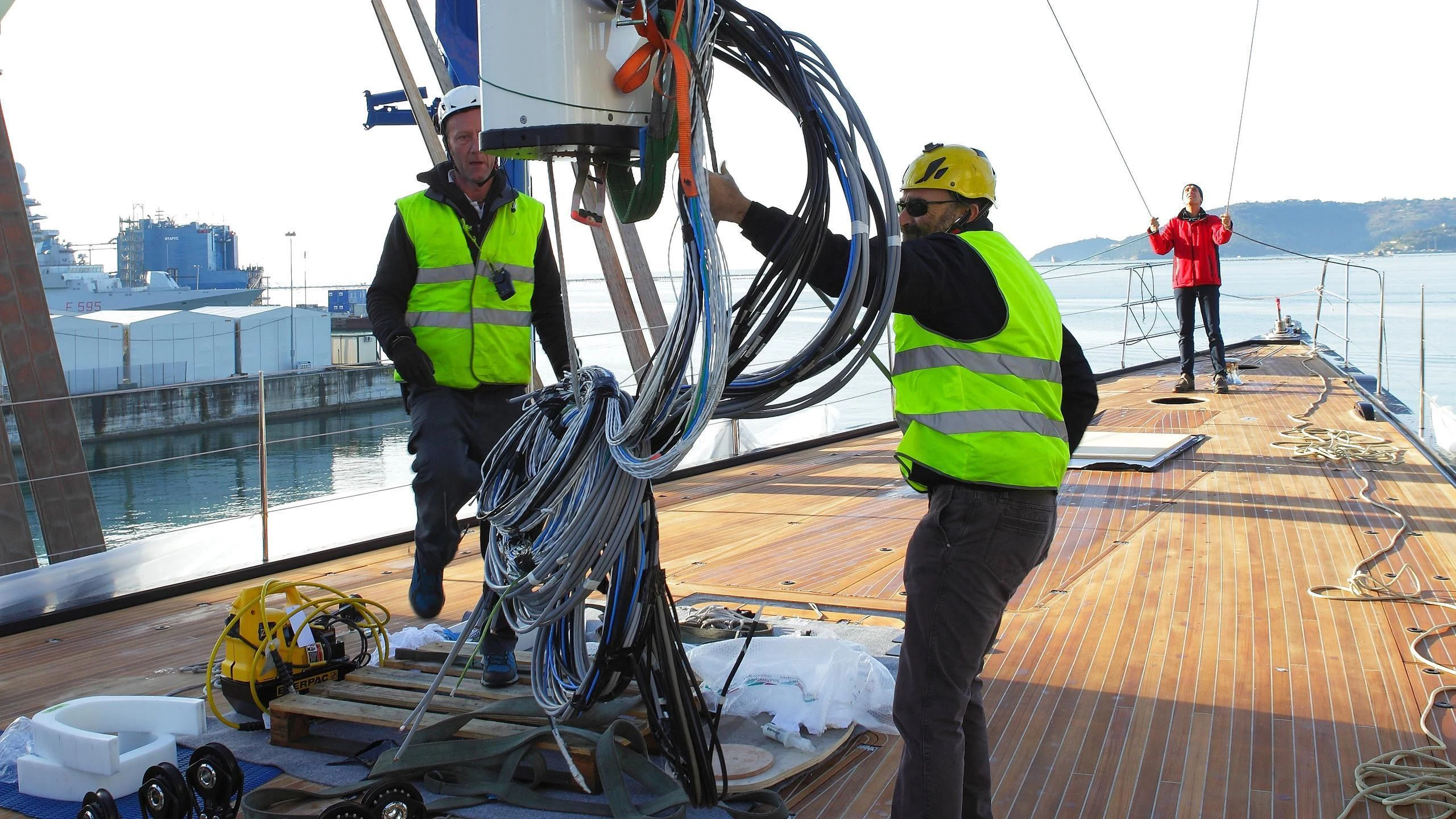 a group of men working on a boat on a dock aboard DAHLAK Yacht for Sale