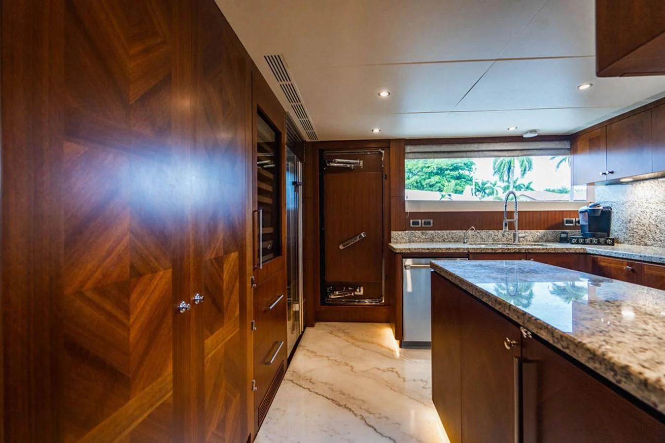 a kitchen with wooden cabinets aboard FAR NIENTE Yacht for Sale