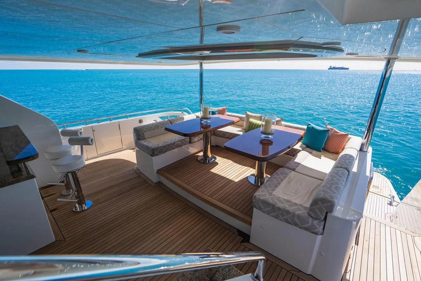 a balcony with a table and chairs on the deck aboard FAR NIENTE Yacht for Sale