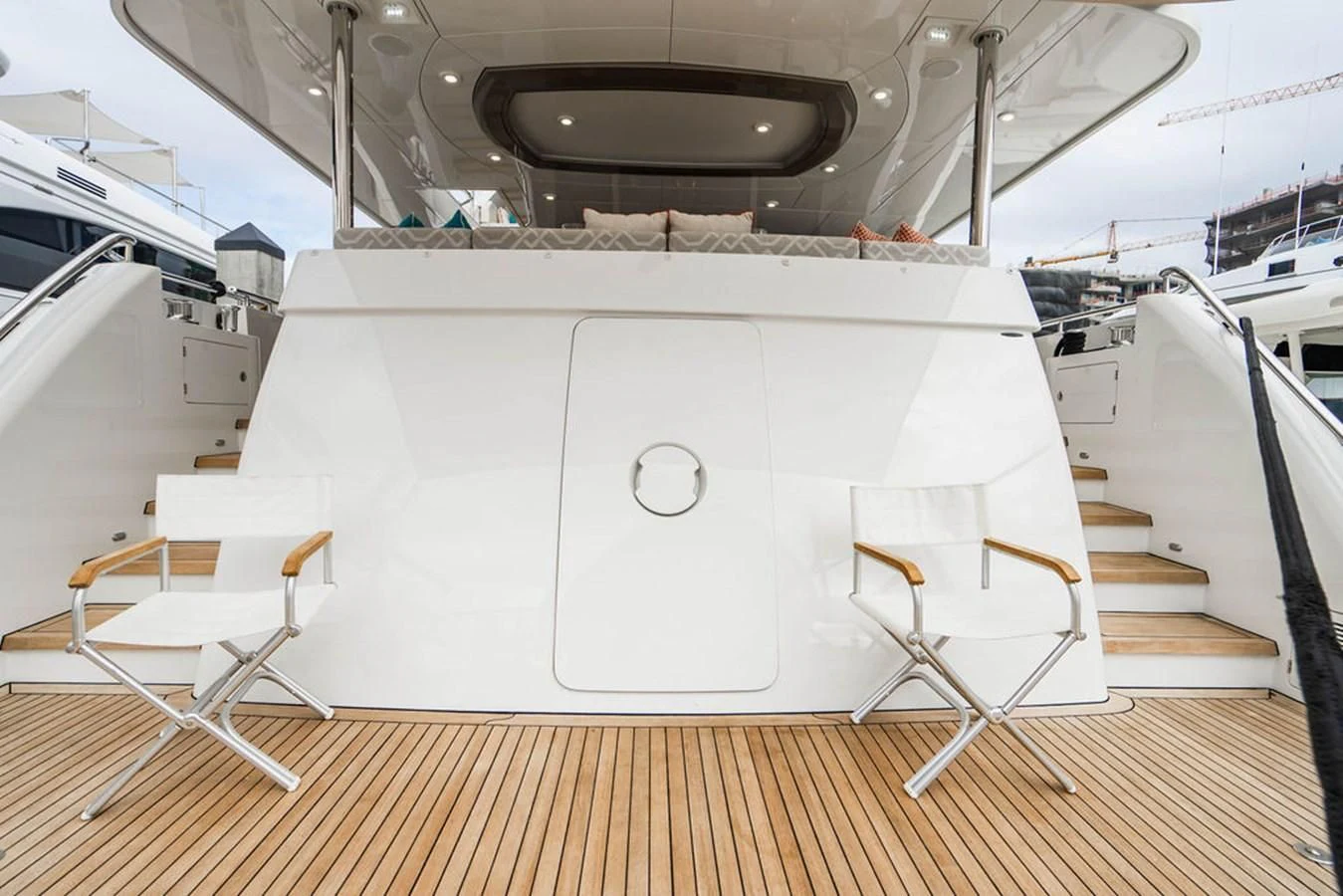 a white rectangular object with a white surface and a chair on a wooden floor aboard FAR NIENTE Yacht for Sale