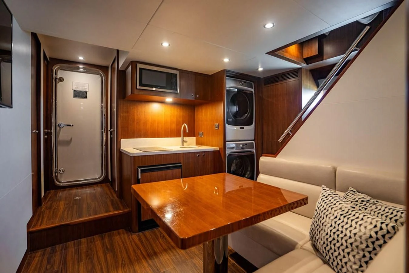 a living room with a table and a tv aboard FAR NIENTE Yacht for Sale