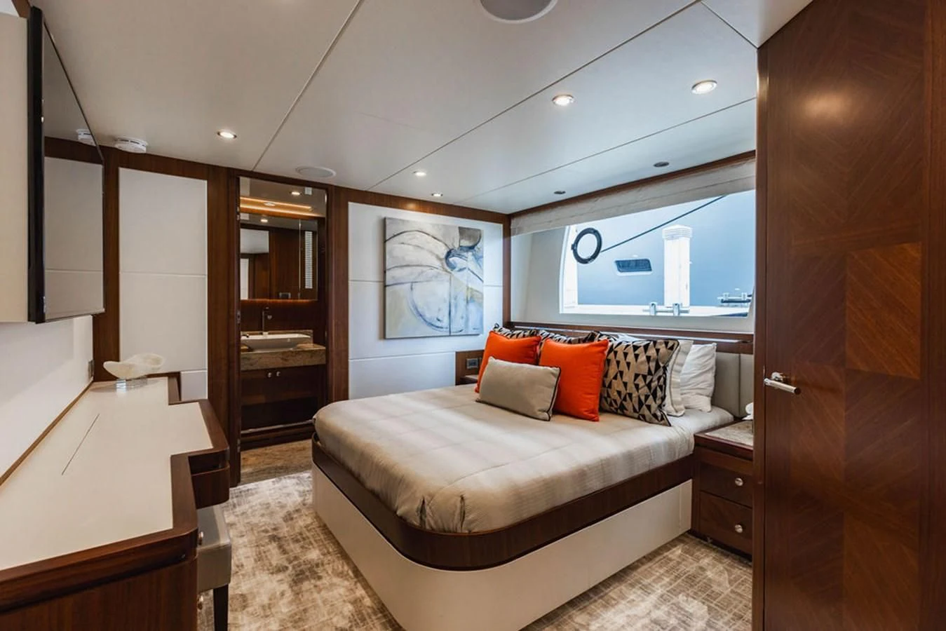 a bedroom with a bed and a wood cabinet aboard FAR NIENTE Yacht for Sale