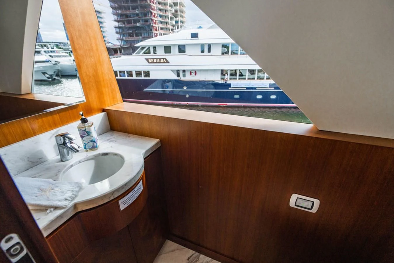 a bathroom sink with a large ship in the background aboard FAR NIENTE Yacht for Sale