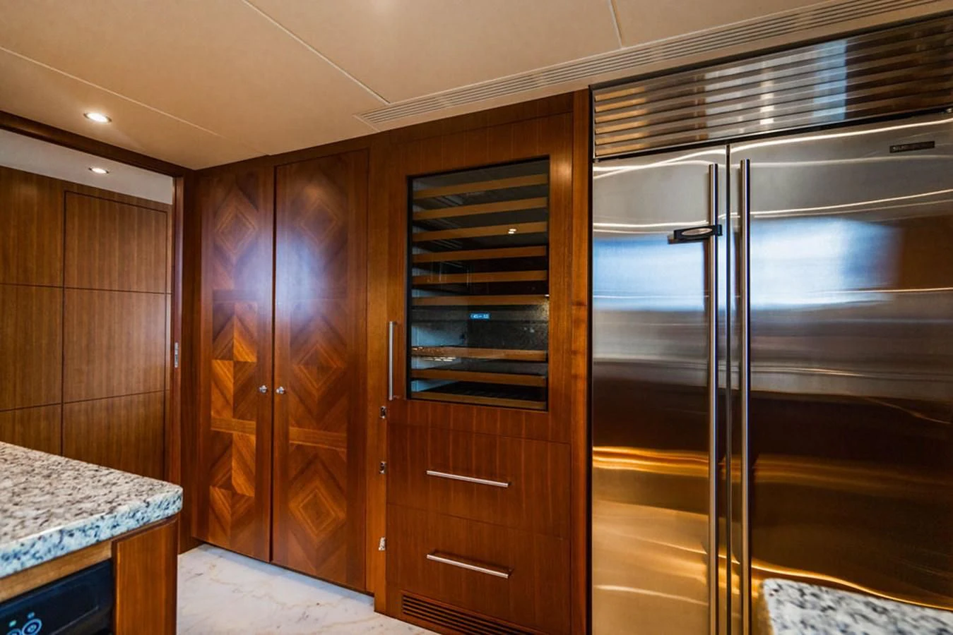 a kitchen with wooden cabinets aboard FAR NIENTE Yacht for Sale