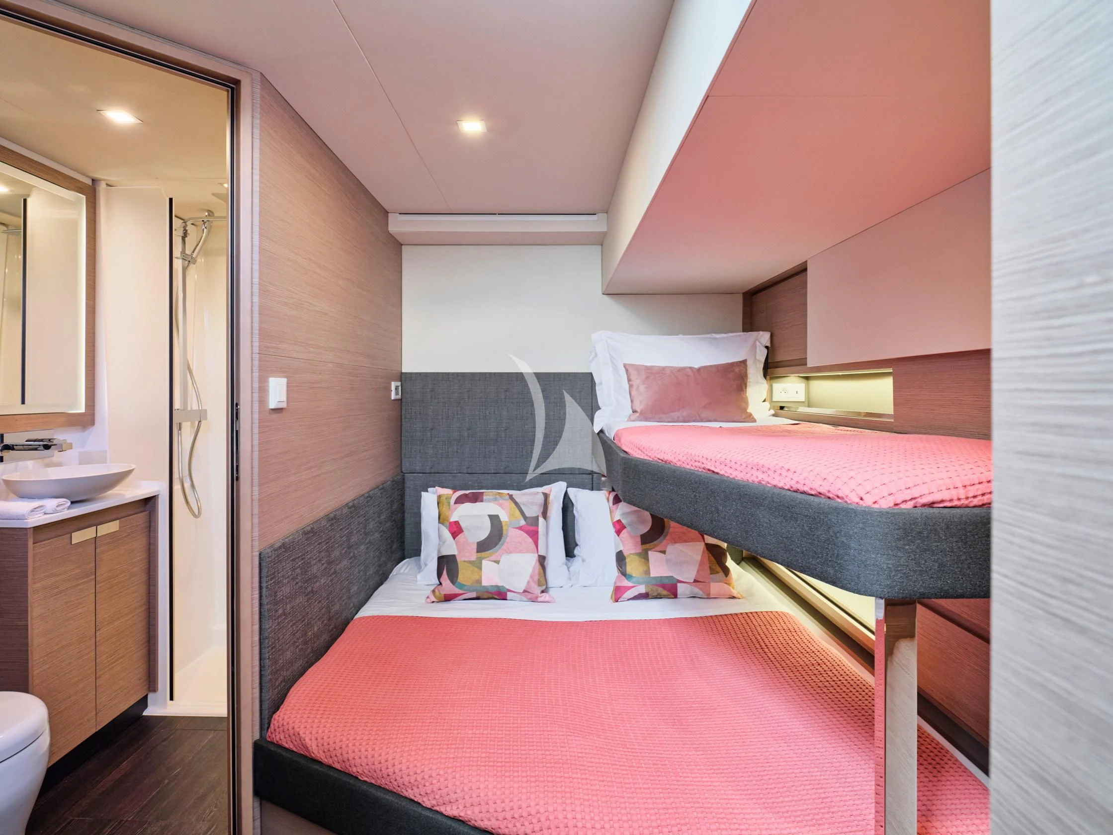 a bedroom with a bed and a pink bed aboard PIXIE Yacht for Charter