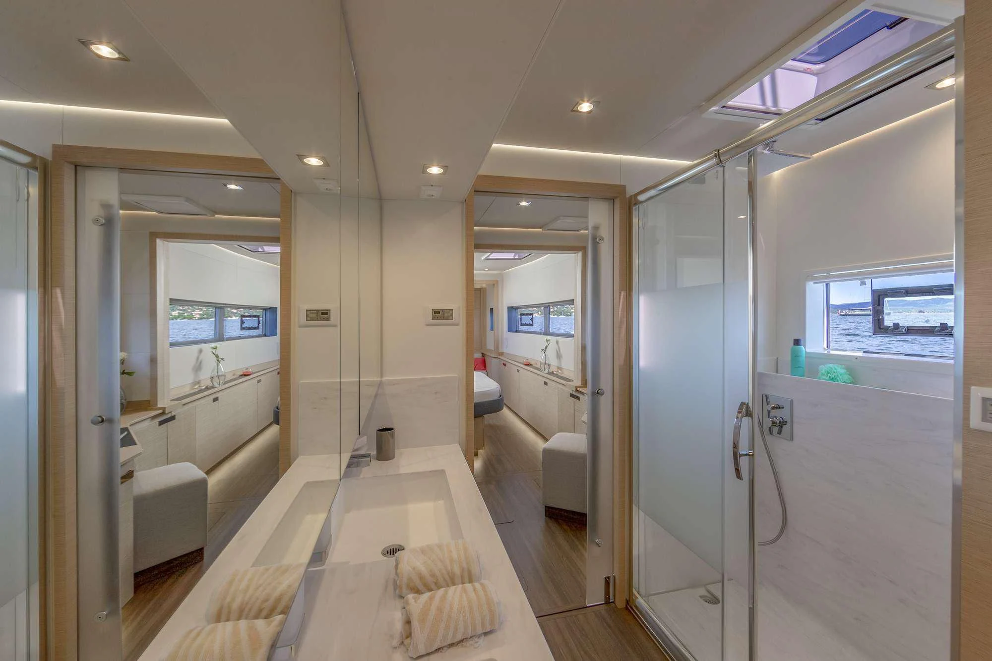 a long hallway with glass doors aboard PIXIE Yacht for Charter
