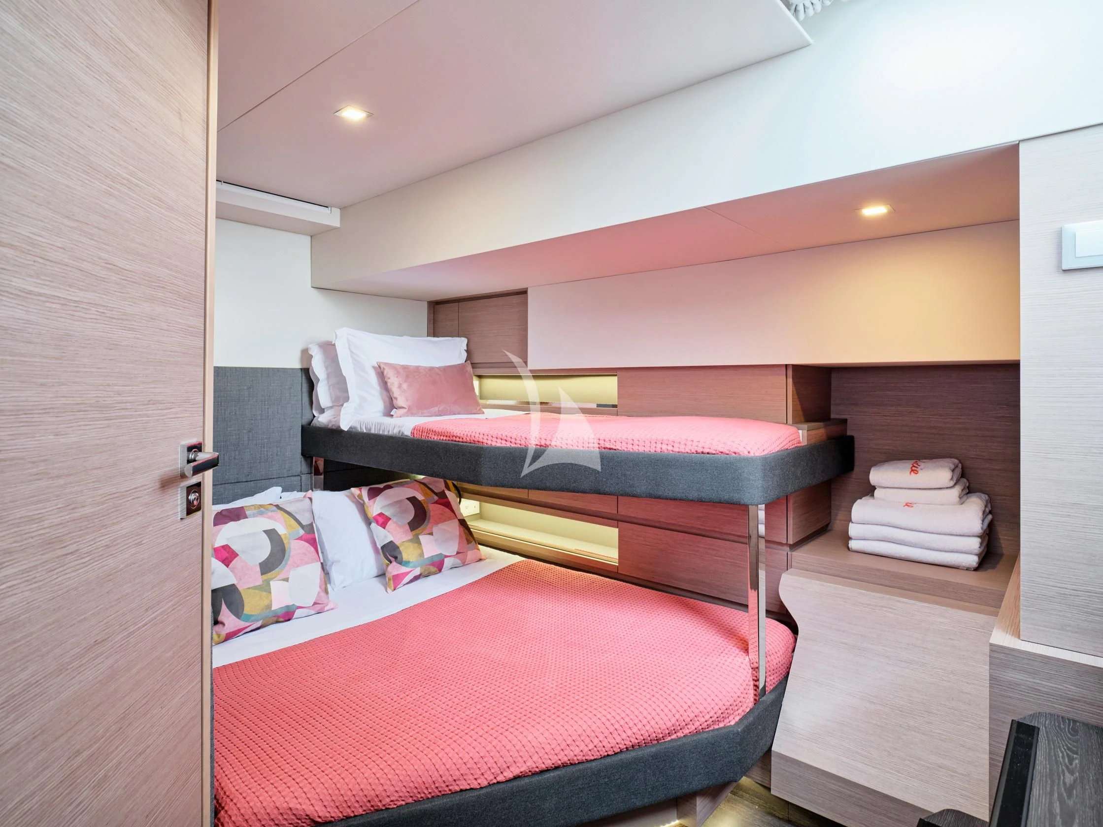 a bed with a red sheet aboard PIXIE Yacht for Charter