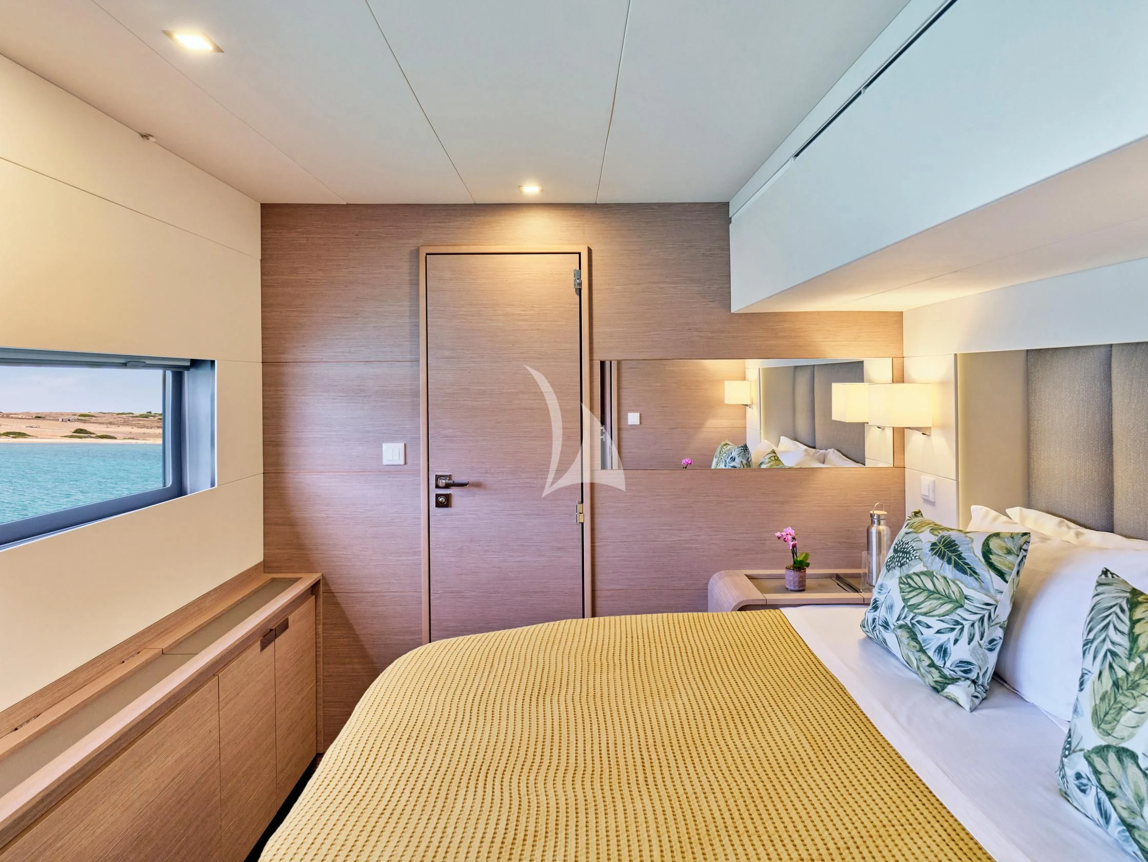 a hotel room with a bed and a television aboard PIXIE Yacht for Charter