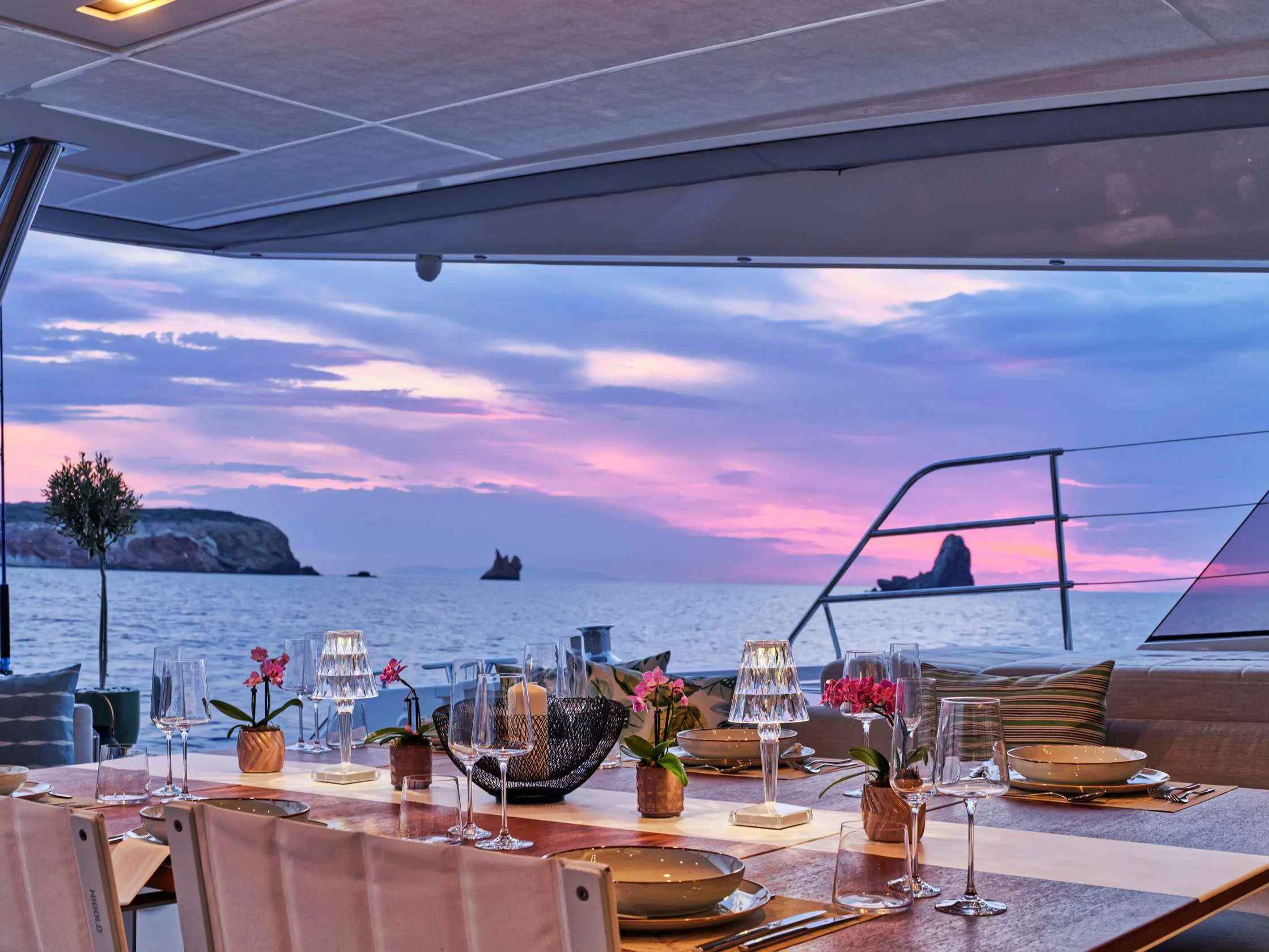 a table set for a dinner party aboard PIXIE Yacht for Charter