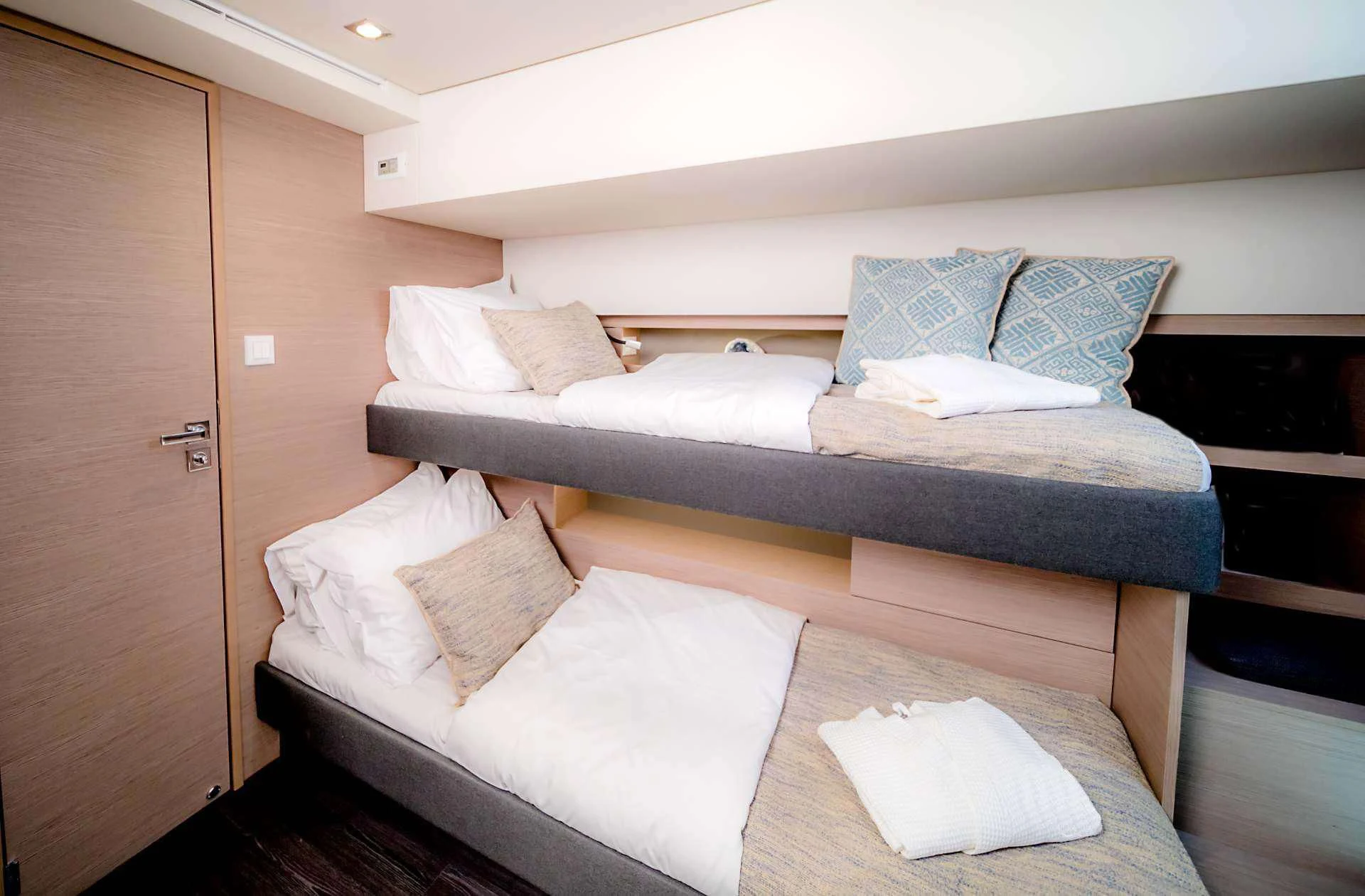 a bed with white pillows aboard PIXIE Yacht for Charter