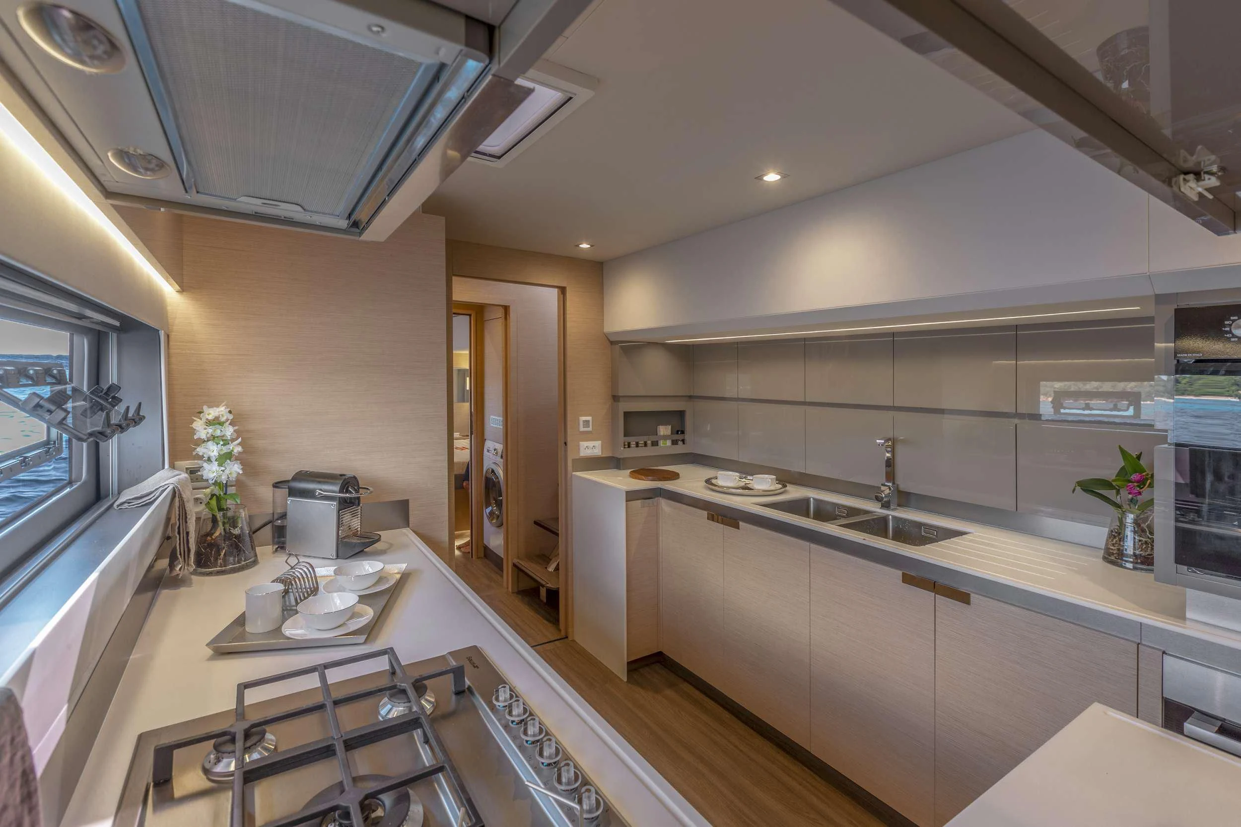 a kitchen with a countertop sink and cabinets aboard PIXIE Yacht for Charter