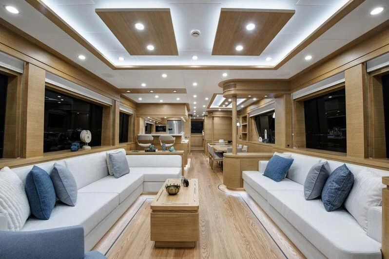 a living room with a couch and a table aboard EMPIRE Yacht for Sale