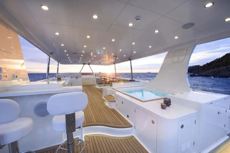 a boat with a table and chairs aboard EMPIRE Yacht for Sale