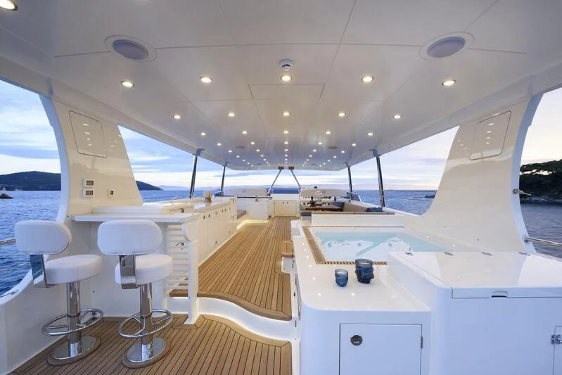 a room with white cabinets and a wood floor aboard EMPIRE Yacht for Sale