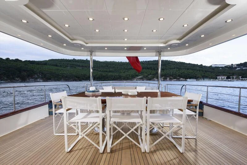 a table and chairs on a deck aboard EMPIRE Yacht for Sale
