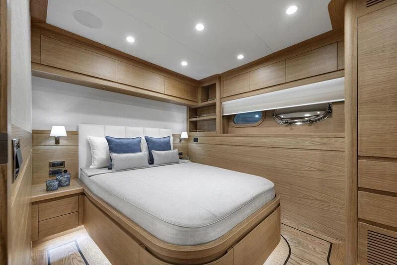 a room with a bed and a shelf with a mirror aboard EMPIRE Yacht for Sale