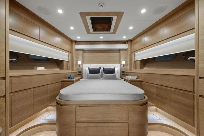 a bedroom with a bed and a wood closet aboard EMPIRE Yacht for Sale