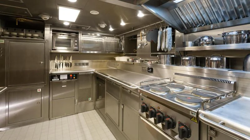a large kitchen with stainless steel appliances aboard MALCOLM MILLER Yacht for Sale