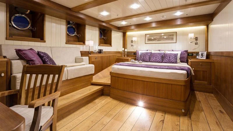 a large bedroom with a bed and a couch aboard MALCOLM MILLER Yacht for Sale