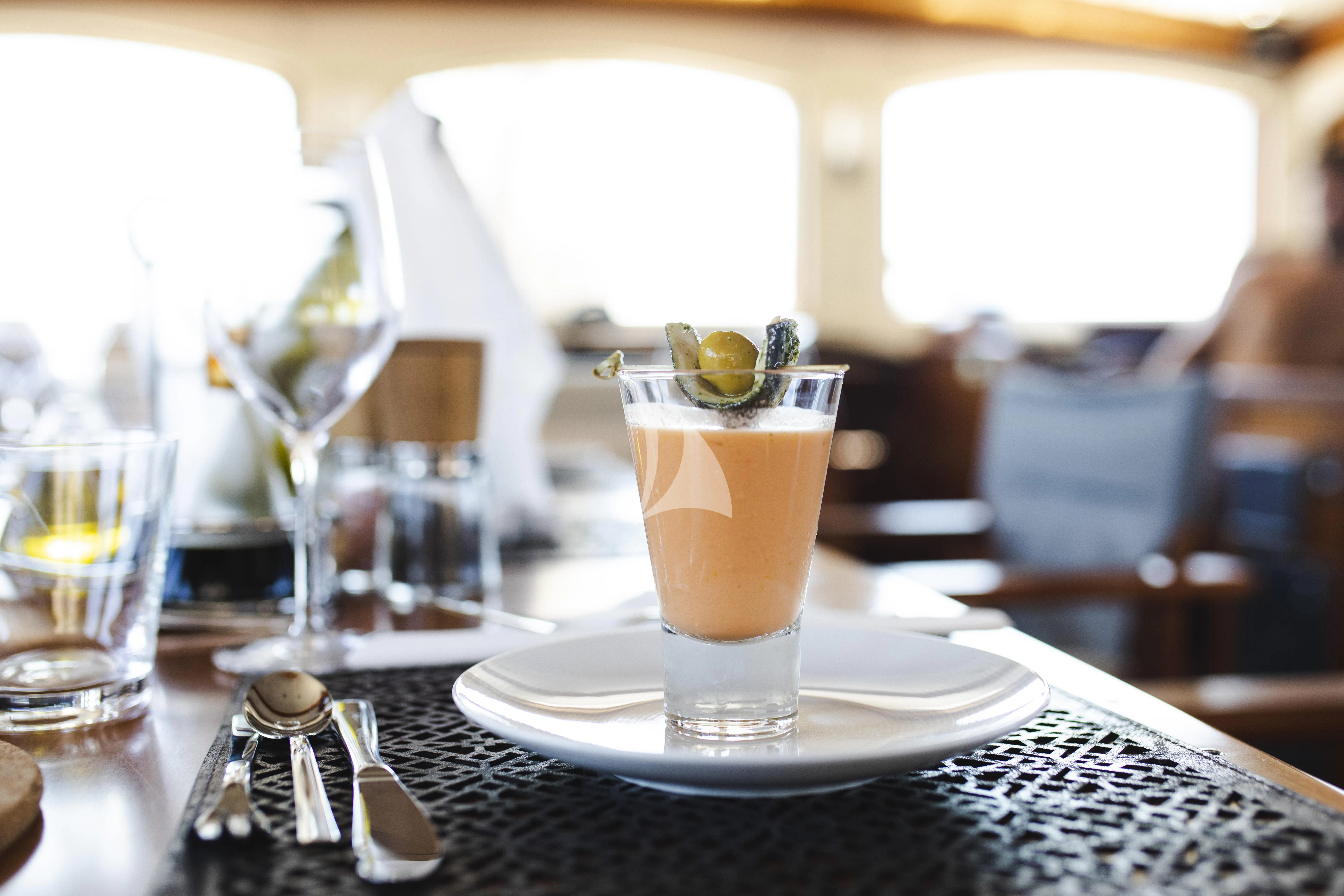 a table with glasses and plates aboard MALCOLM MILLER Yacht for Sale