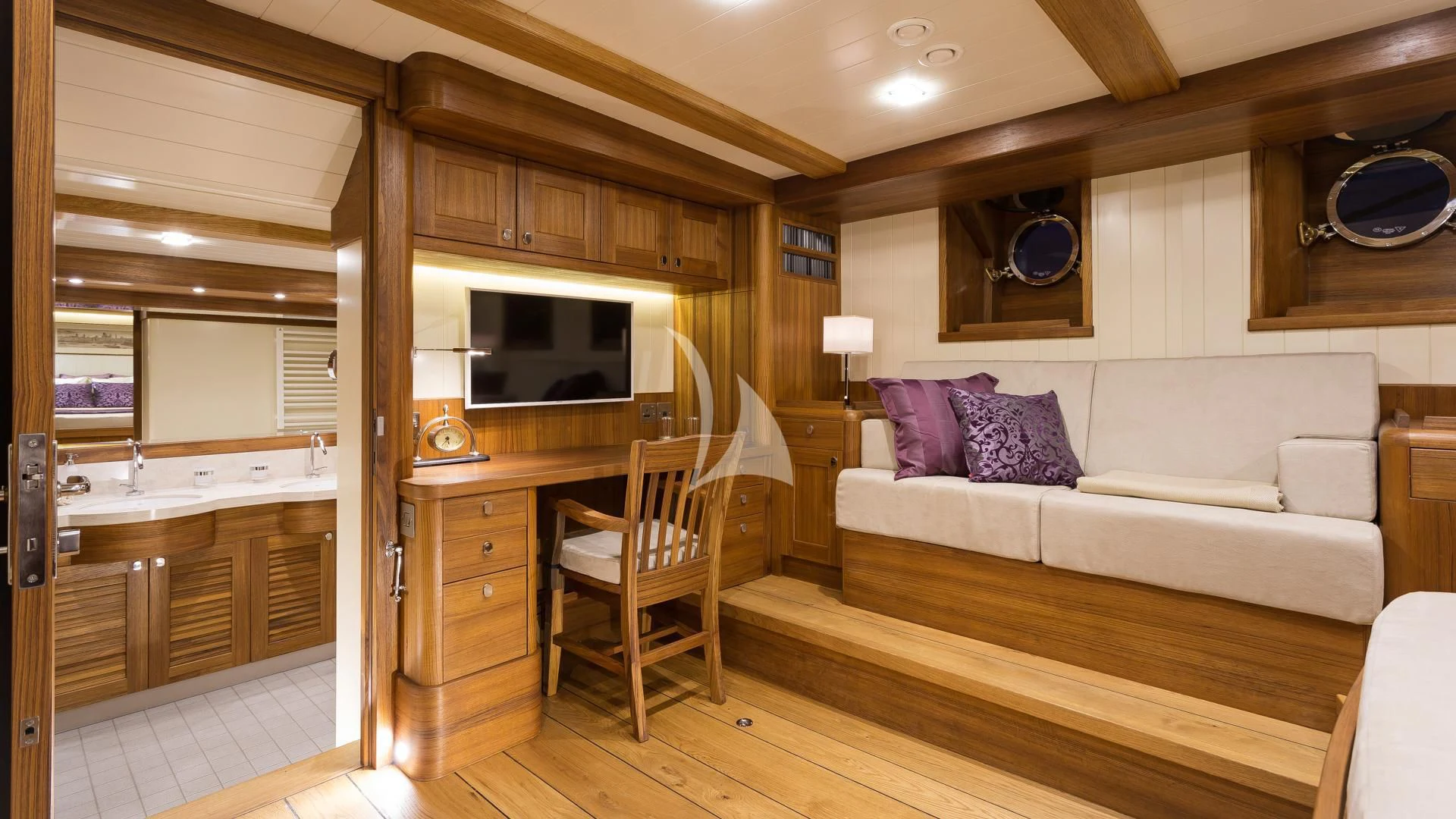 a living room with a couch and a tv aboard MALCOLM MILLER Yacht for Sale