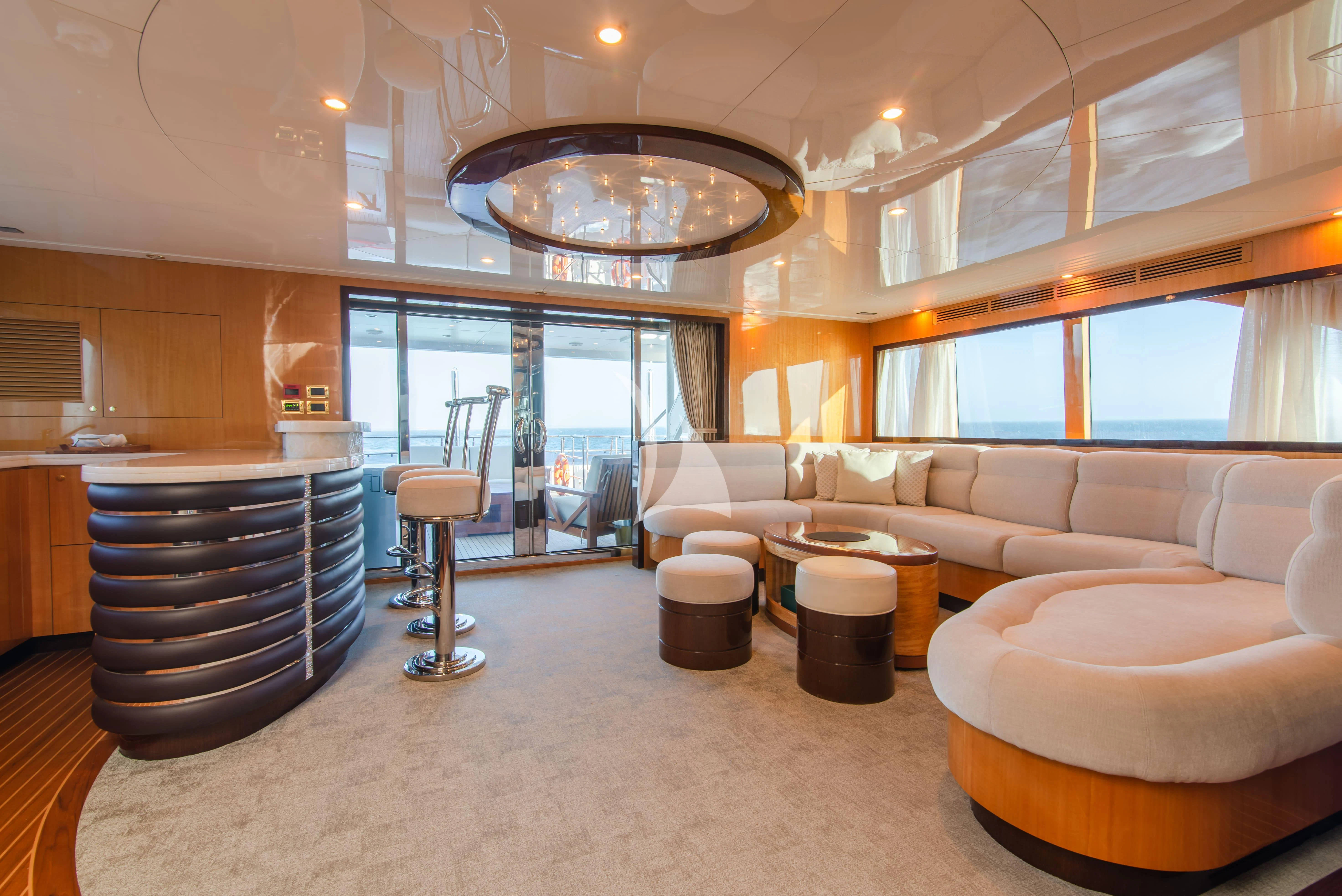 a large living room with a large chandelier aboard INTRIGUE Yacht for Sale
