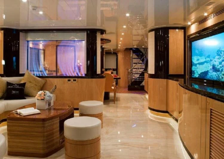 a living room with a large tv aboard INTRIGUE Yacht for Sale