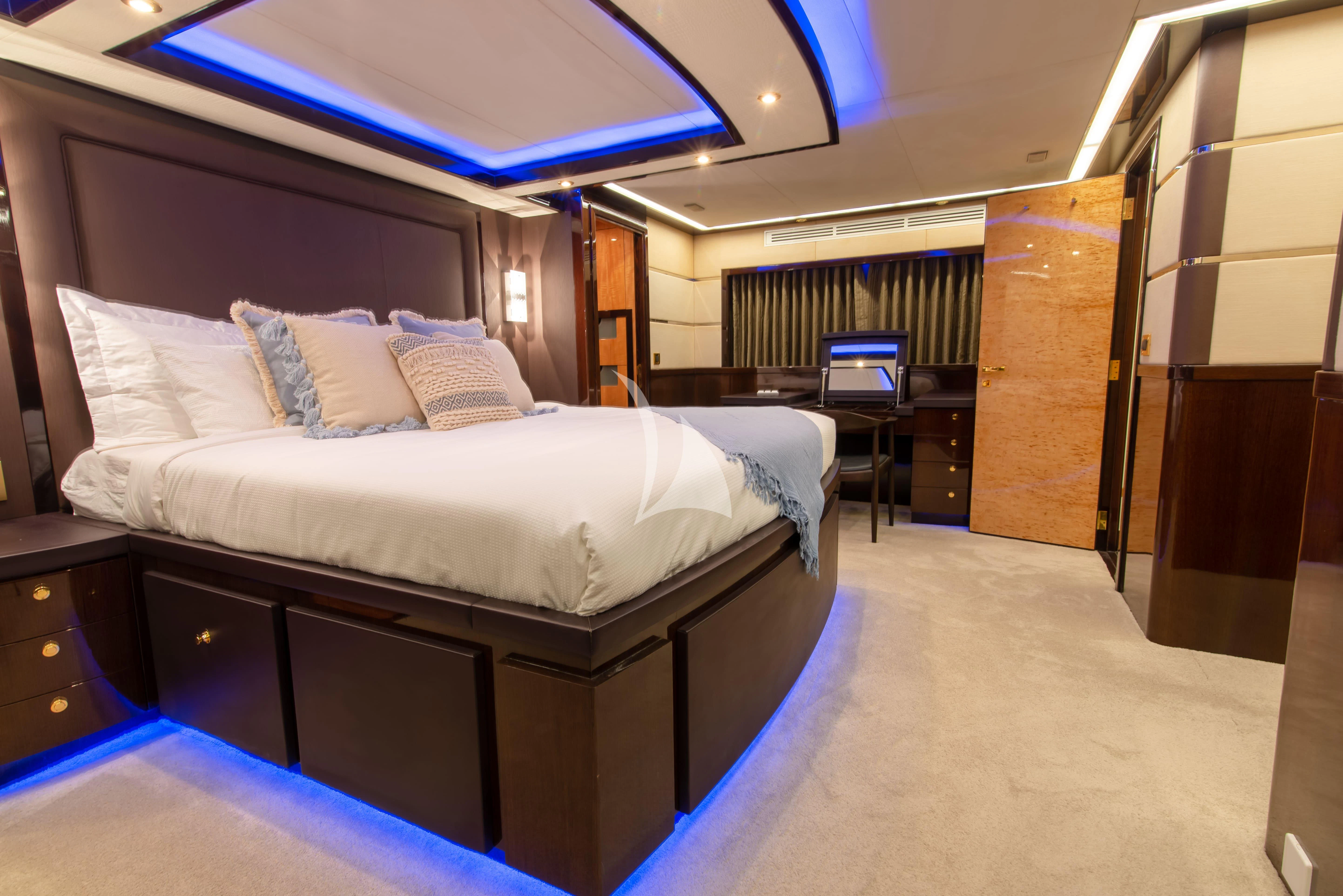 a room with a bed and a desk aboard INTRIGUE Yacht for Sale
