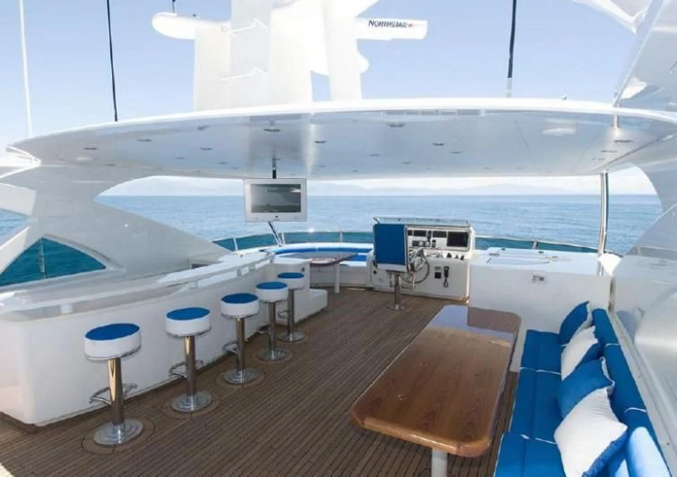 a boat with stools and stools on the deck aboard INTRIGUE Yacht for Sale