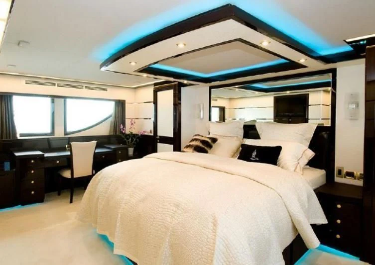 a bedroom with a large bed aboard INTRIGUE Yacht for Sale
