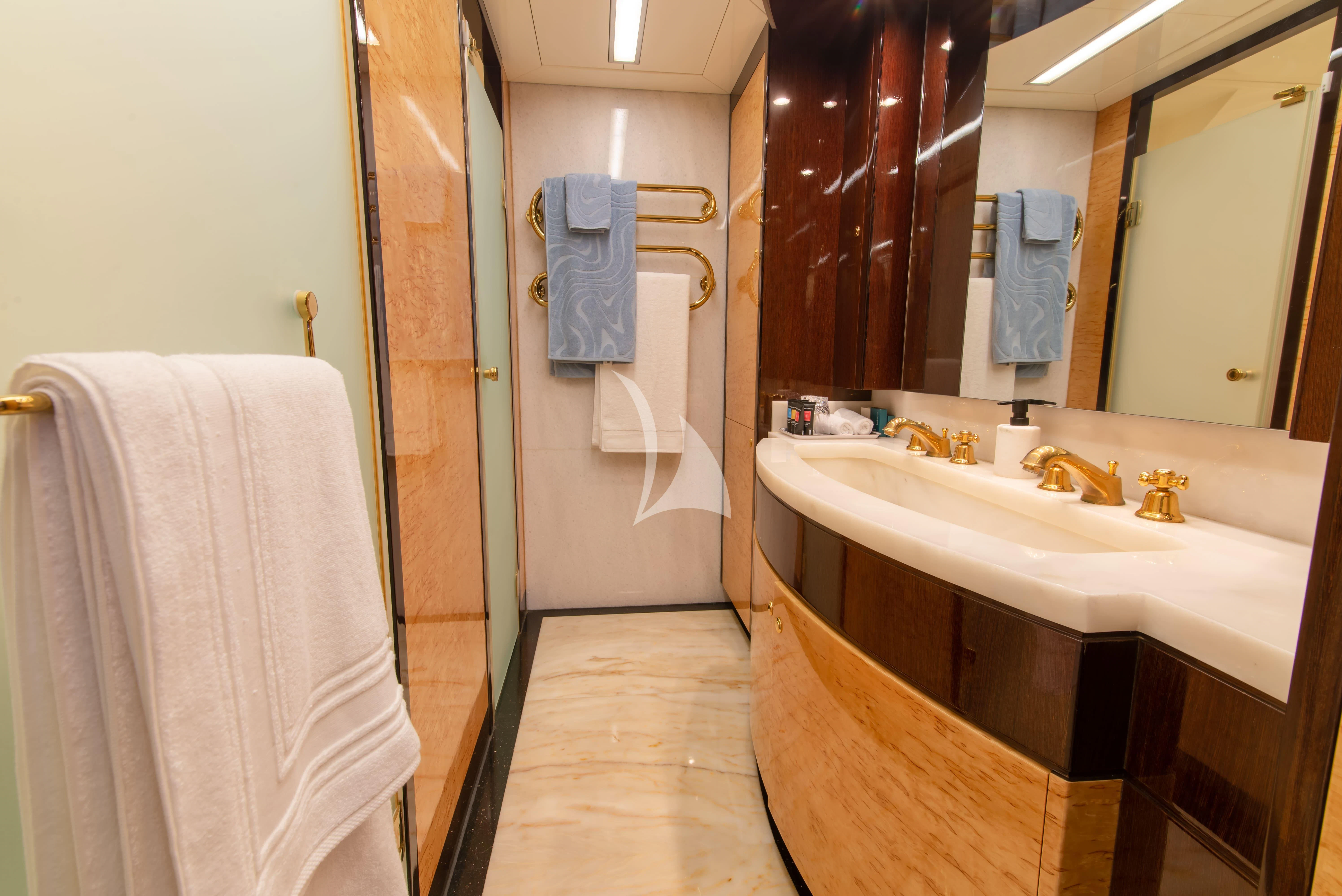 a bathroom with a sink and towels aboard INTRIGUE Yacht for Sale