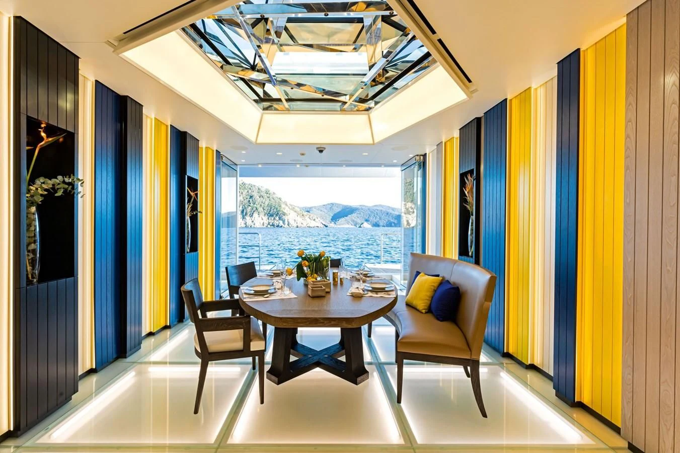 a room with a table chairs and a window aboard LUMINOSITY Yacht for Sale