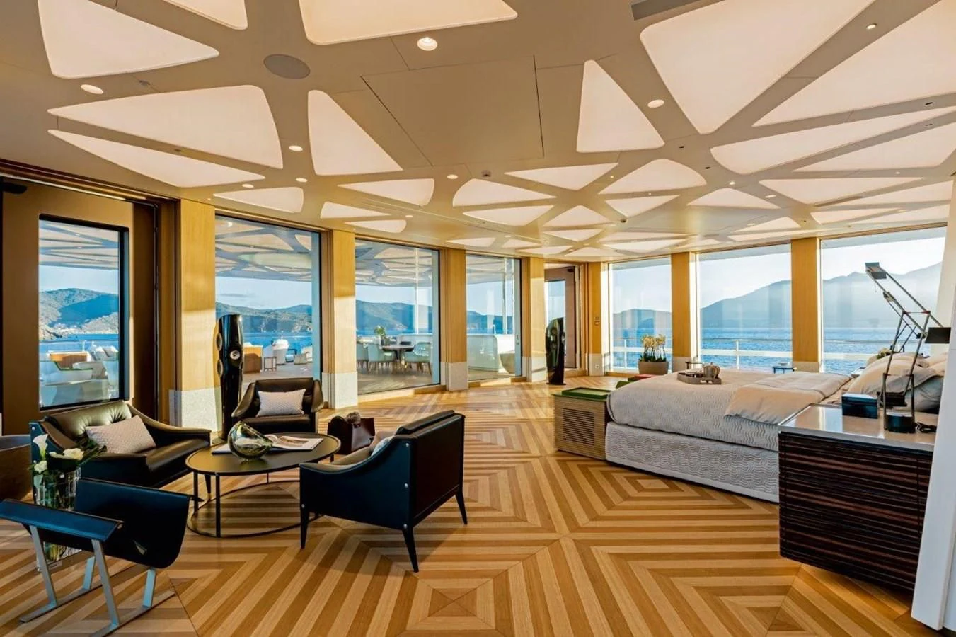 a room with a bed and a desk aboard LUMINOSITY Yacht for Sale