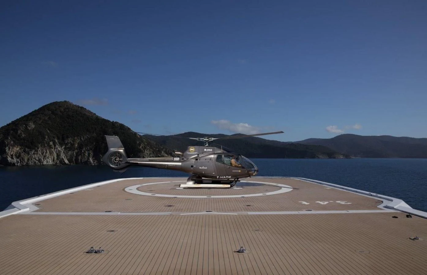 a helicopter on a runway aboard LUMINOSITY Yacht for Sale