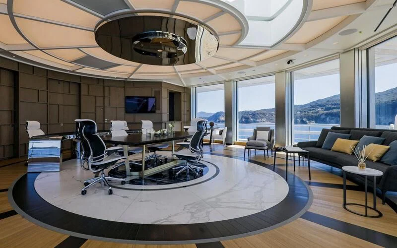 a room with a table and chairs aboard LUMINOSITY Yacht for Sale