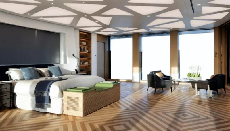 a large room with a bed and a couch aboard LUMINOSITY Yacht for Sale